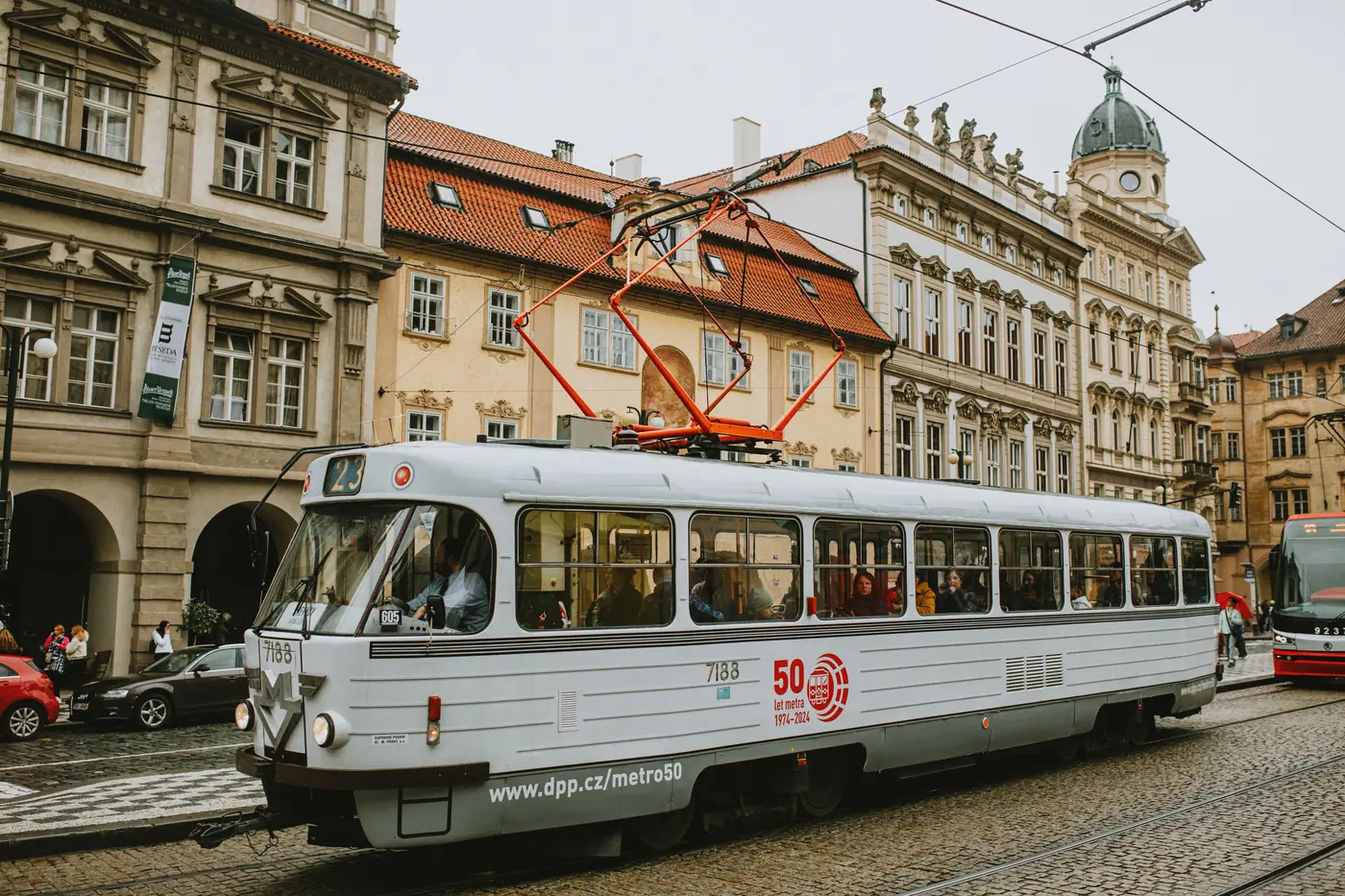 A historic tram on a busy street in Prague