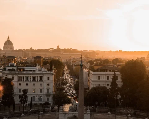 Rome at sunrise seen from Piazza del Popolo with the city's domes in the distance