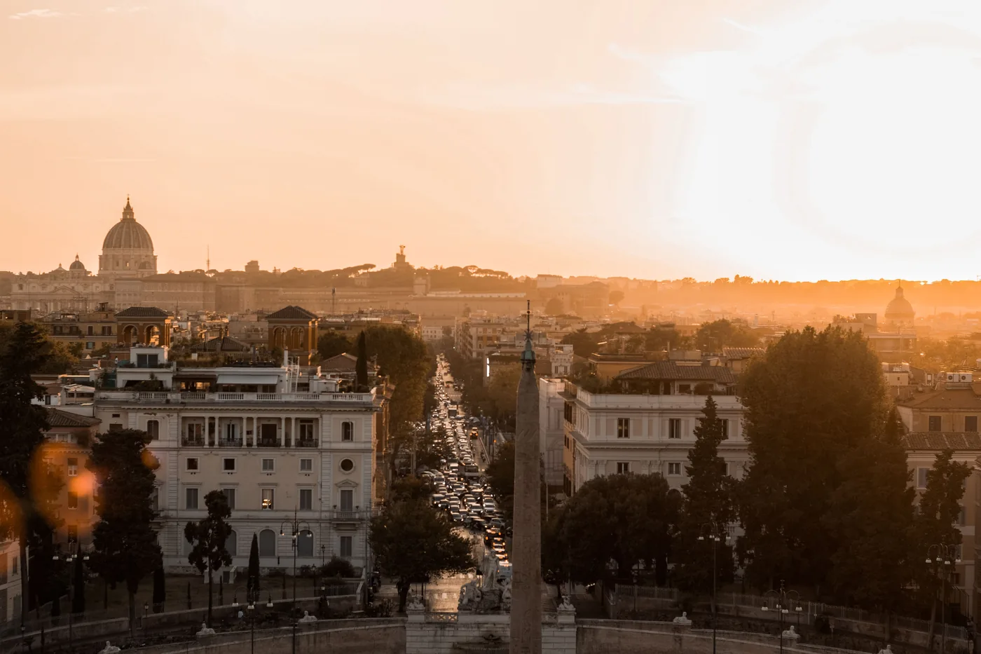 Rome at sunrise seen from Piazza del Popolo with the city's domes in the distance
