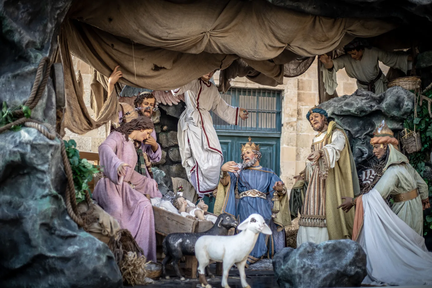 A life size nativity scene with painted figures