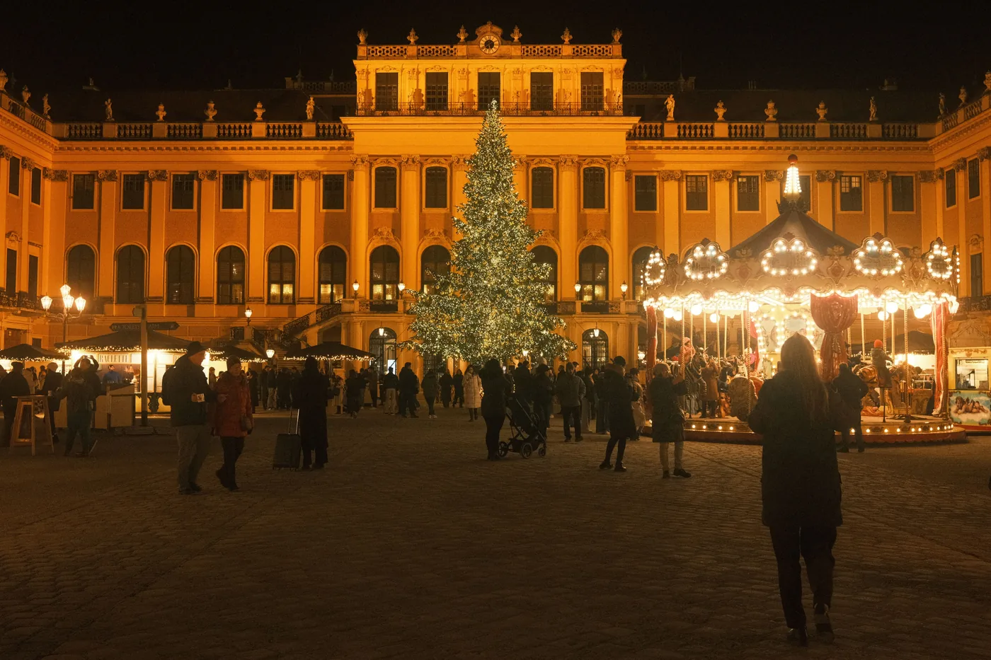 Christmas market stalls in the floodlit forecourt of Schönbrunn Palace in Vienna