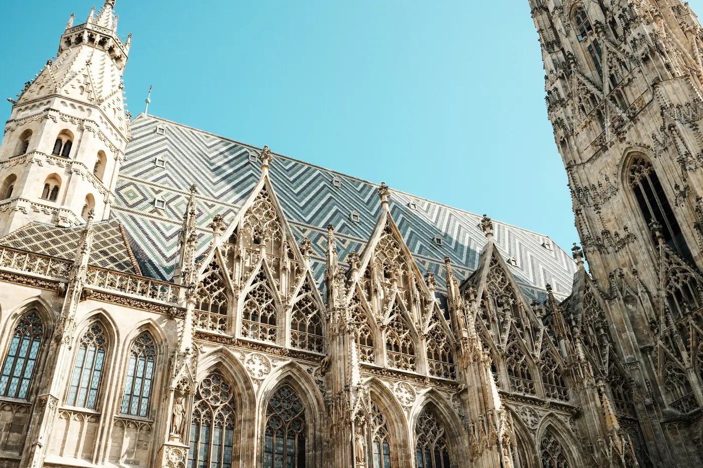 The gothic stonework and patterned tile roof of St Stephen's Cathedral in Vienna