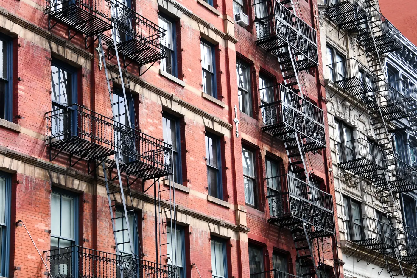 Brick tenement buildings with iron fire escapes in New York
