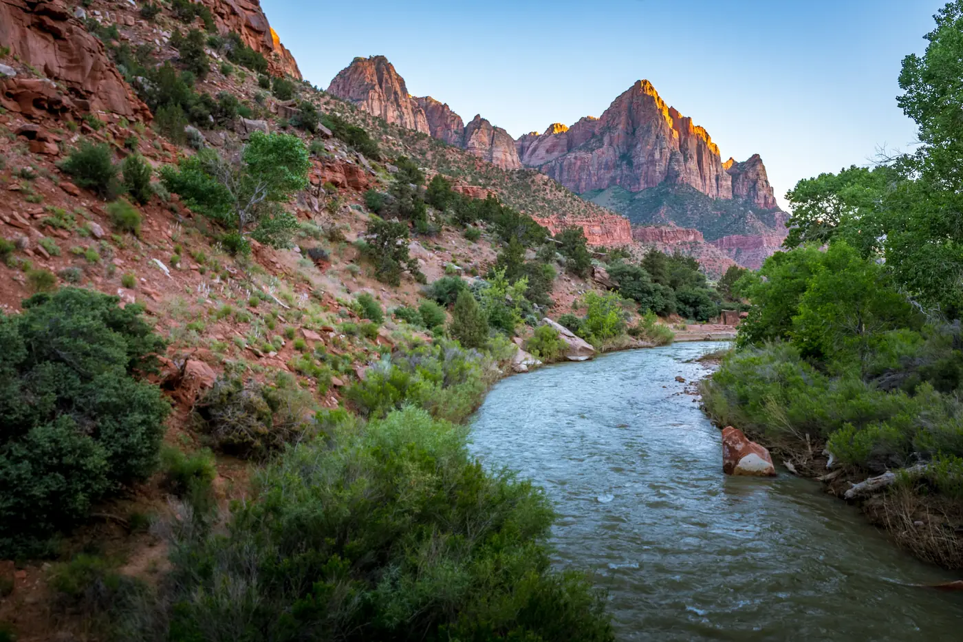 The Watchman lit at sunset above the Virgin River in Zion National Park