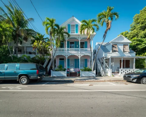 Historic wooden houses with palm trees on a street in Key West