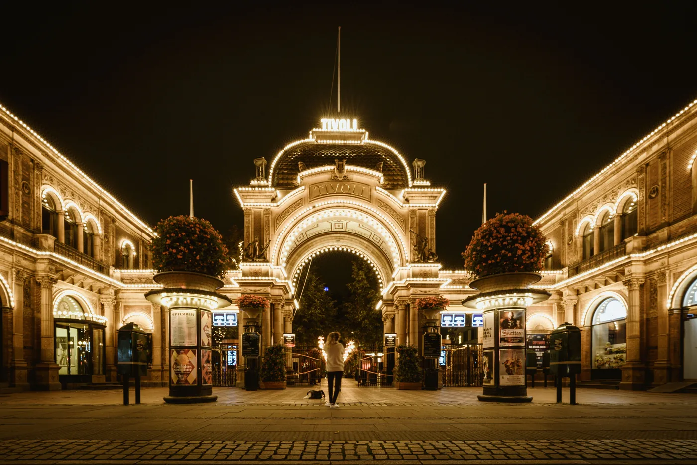 The lit up main entrance to Tivoli Gardens in Copenhagen at night