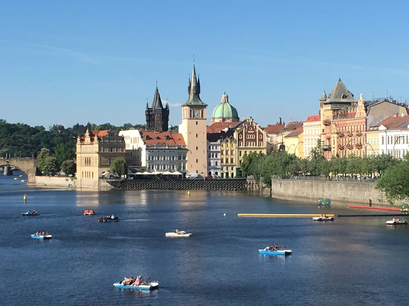 Small boats out on the Vltava River below Prague's Old Town waterfront