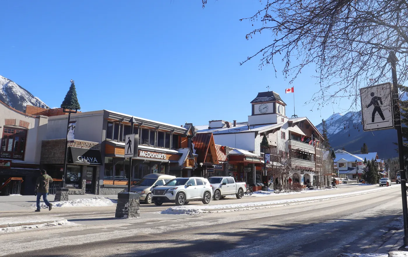 A snowy winter street scene in the town of Banff