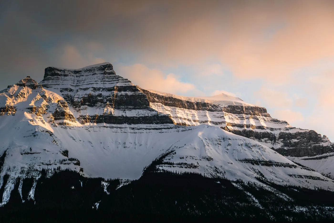 A snowy peak glowing at sunset in Banff National Park