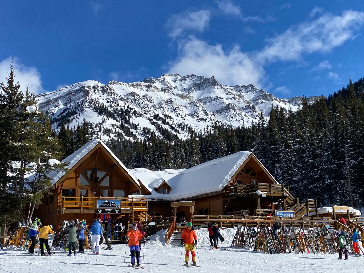 A busy ski lodge below snowy peaks near Banff