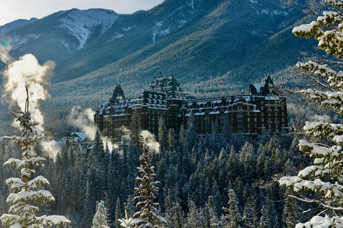 The Fairmont Banff Springs hotel among snowy trees in winter