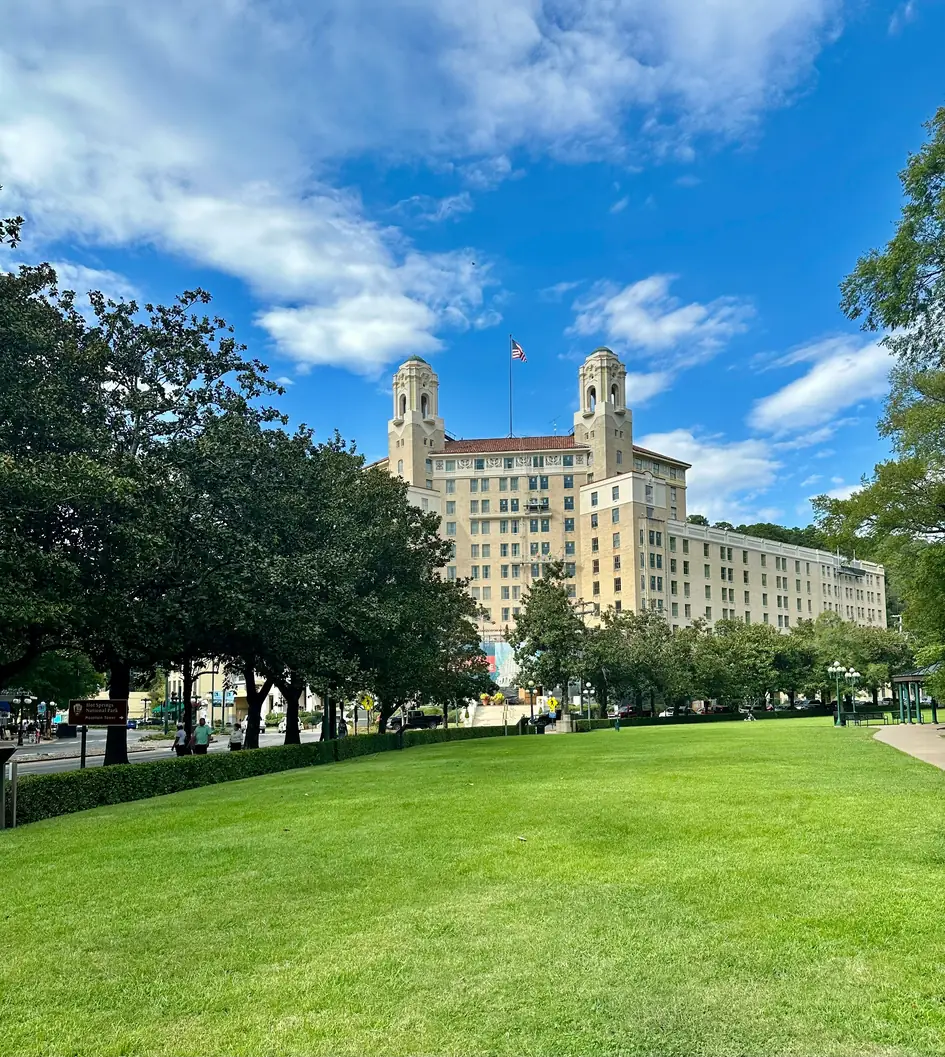 The historic Arlington Hotel rising above a green lawn in Hot Springs, Arkansas
