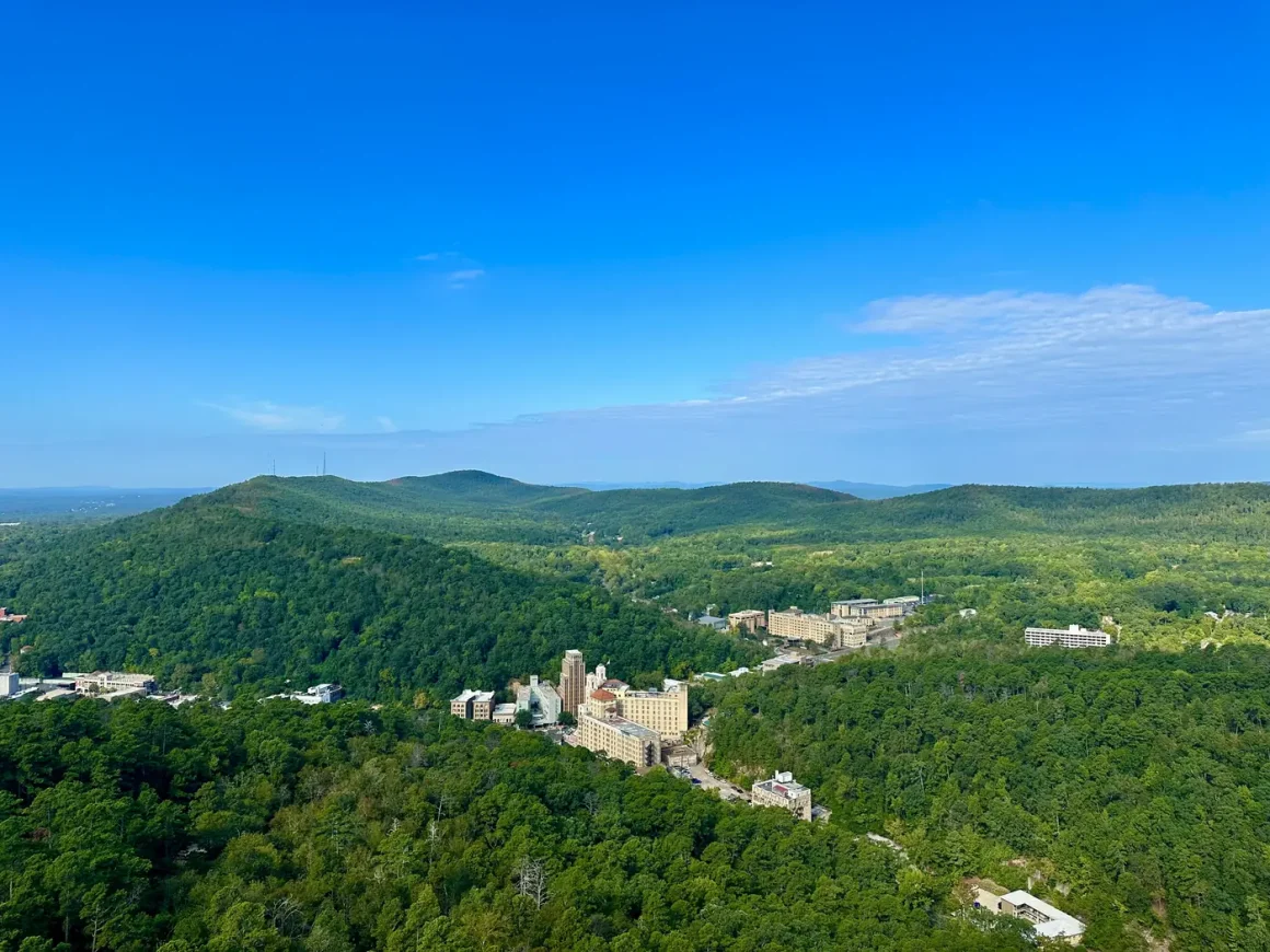 Downtown Hot Springs tucked among the forested Ouachita Mountains, seen from Hot Springs Mountain