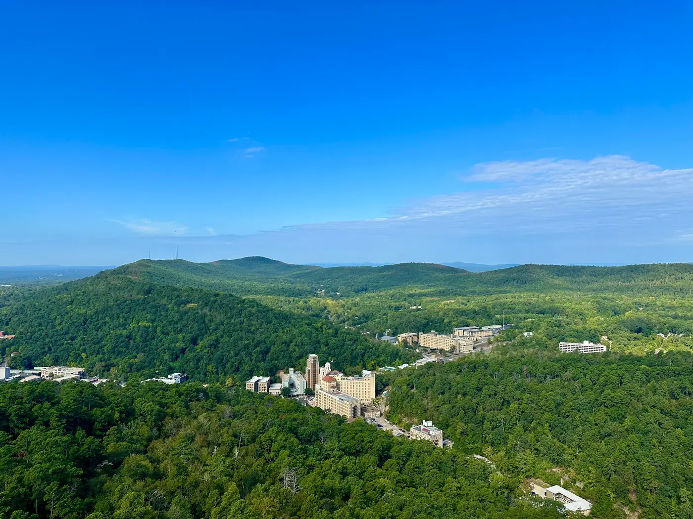 Downtown Hot Springs tucked among the forested Ouachita Mountains, seen from Hot Springs Mountain