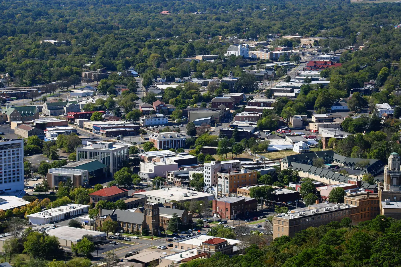 A view from above over downtown Hot Springs and its tree covered hills