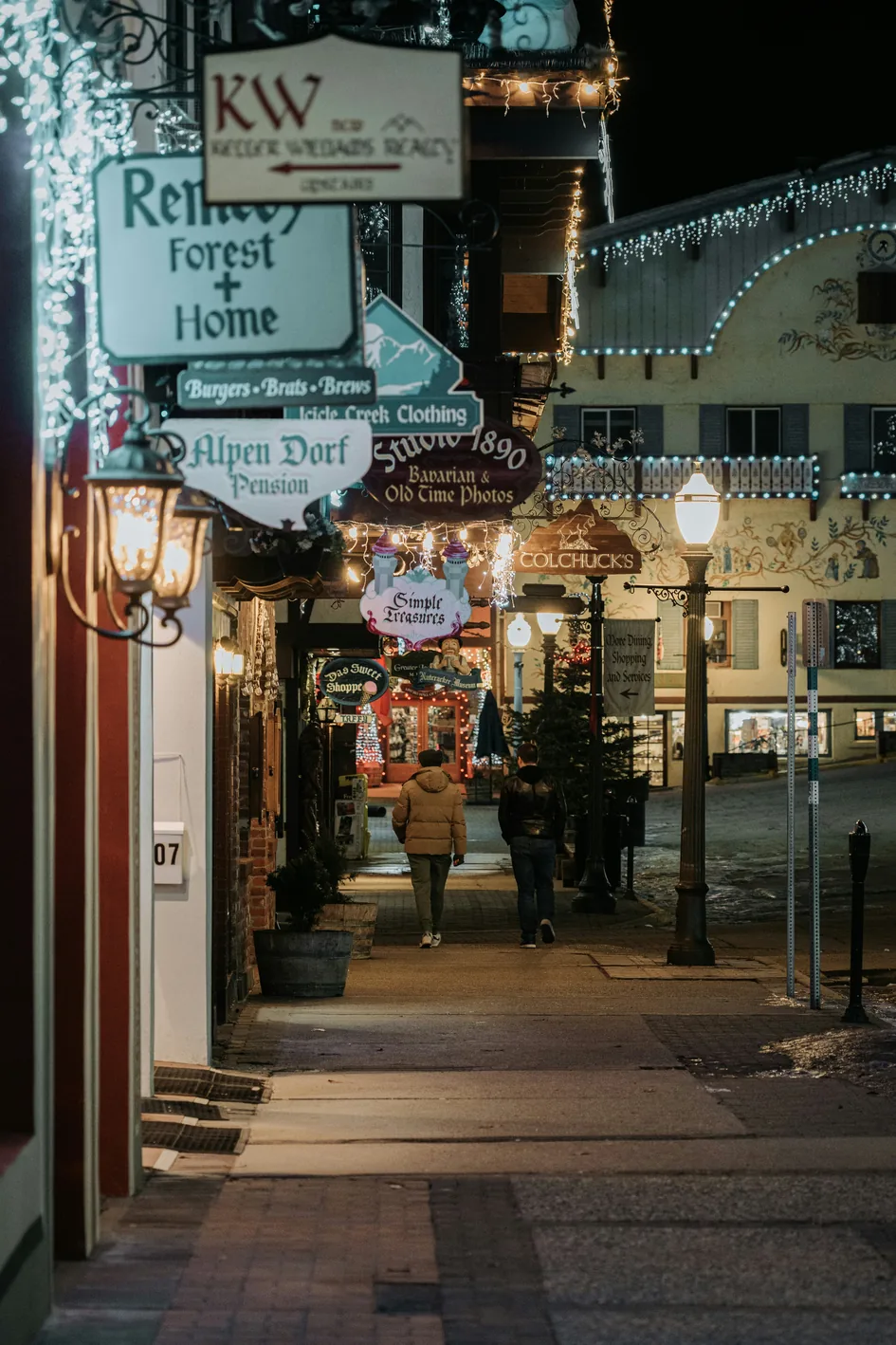 Shop signs and holiday lights along a Leavenworth street at night