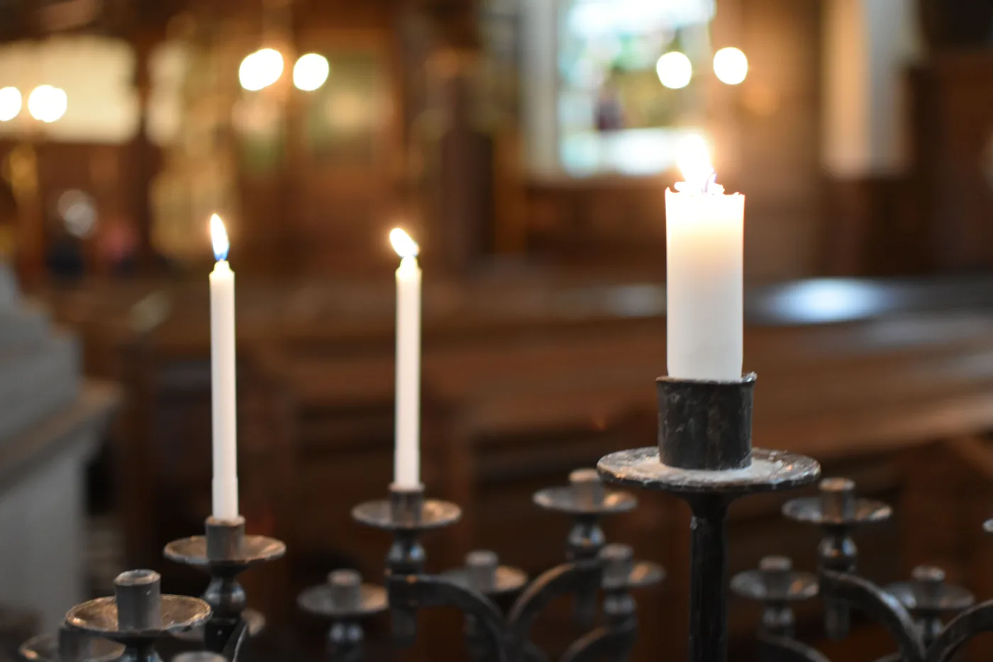 Candles burning in a dark church