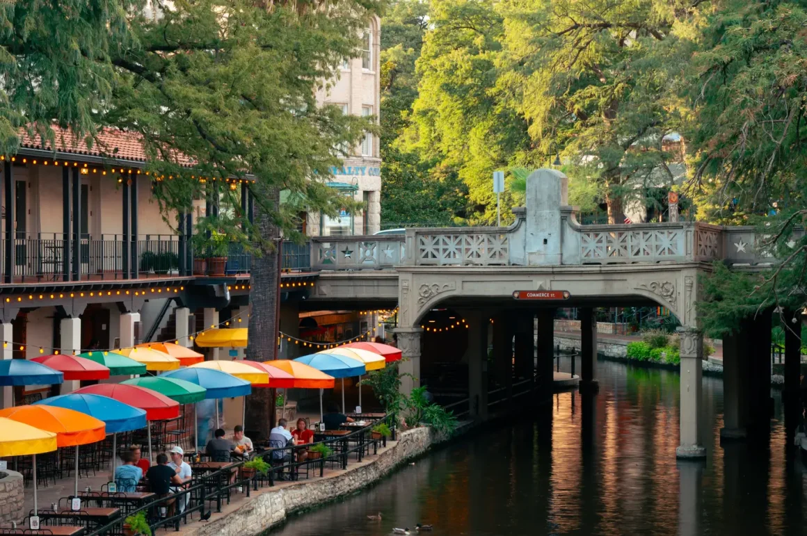 Colorful umbrellas and cafe tables along the San Antonio River Walk