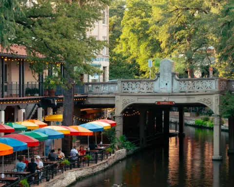 Colorful umbrellas and cafe tables along the San Antonio River Walk