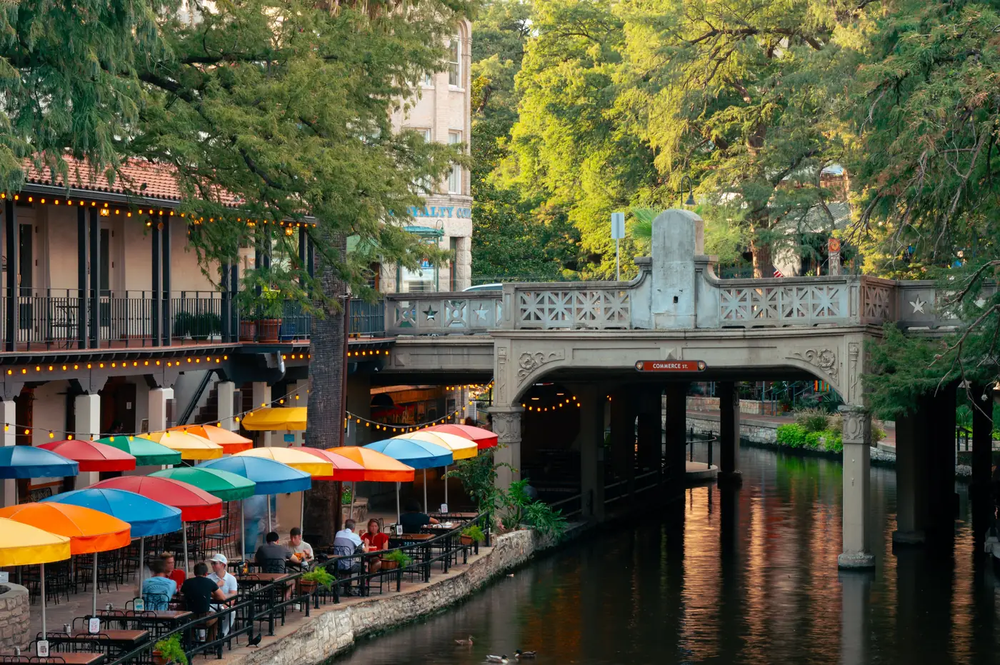 Colorful umbrellas and cafe tables along the San Antonio River Walk
