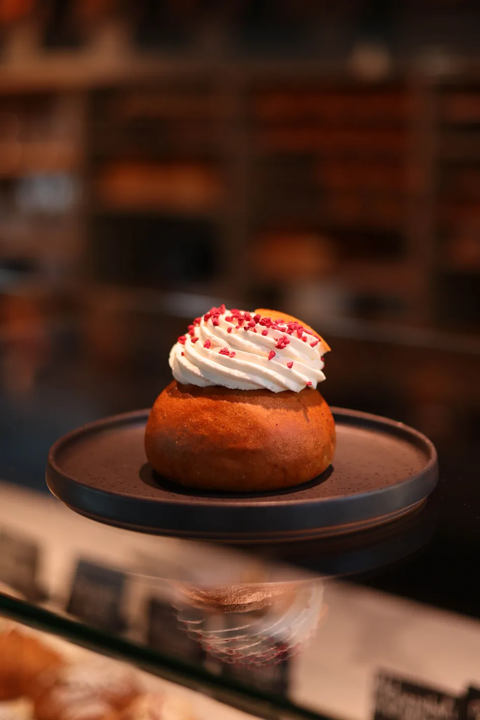 A semla bun filled with whipped cream at a bakery
